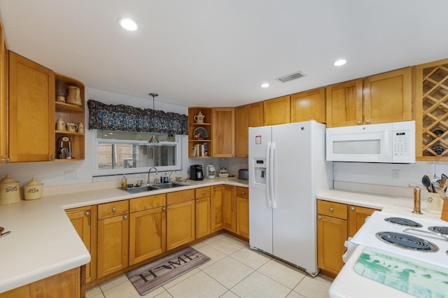 kitchen with light tile patterned floors, white appliances, decorative light fixtures, and sink