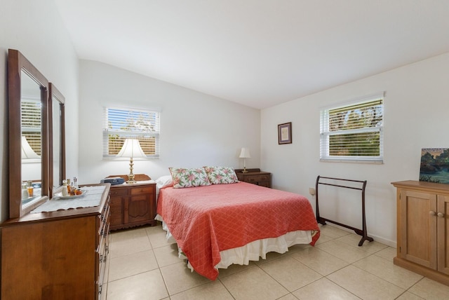 tiled bedroom featuring vaulted ceiling