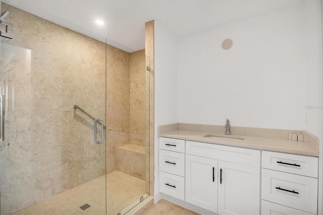 bathroom with vanity and a shower with shower door