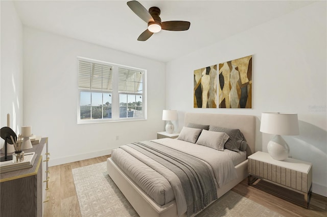 bedroom featuring ceiling fan and light hardwood / wood-style flooring