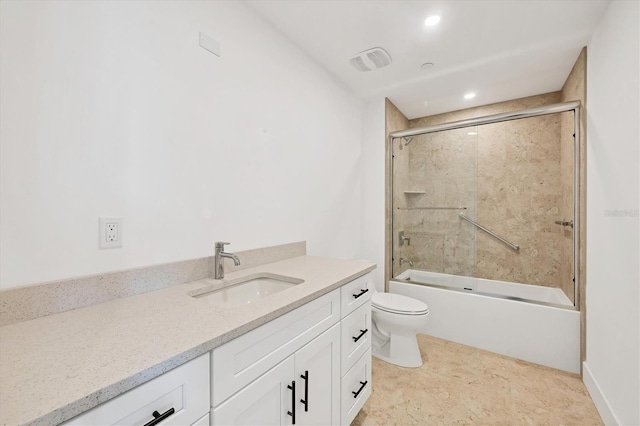 full bathroom featuring combined bath / shower with glass door, vanity, and toilet