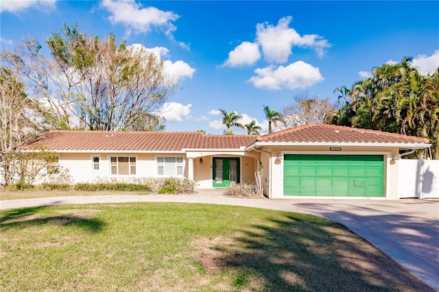 view of front of house with french doors, a front yard, and a garage