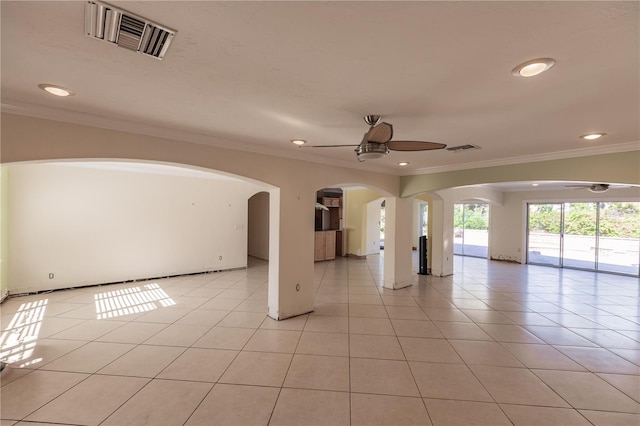 unfurnished room with ceiling fan, light tile patterned flooring, and ornamental molding