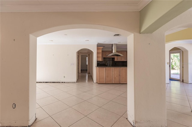 tiled empty room featuring ornamental molding and sink