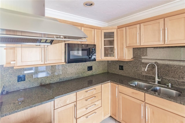 kitchen featuring island exhaust hood, sink, dark stone counters, and ornamental molding