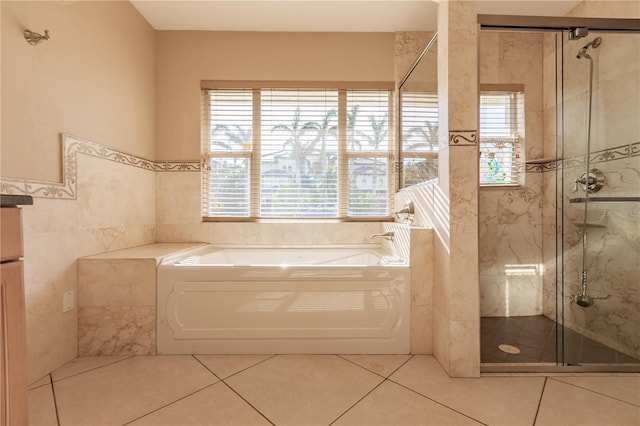 bathroom featuring tile patterned floors, shower with separate bathtub, tile walls, and a wealth of natural light