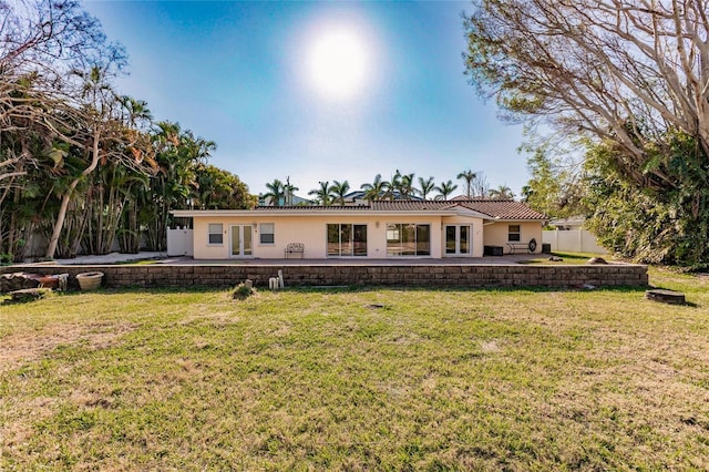 view of front of house with a patio and a front lawn