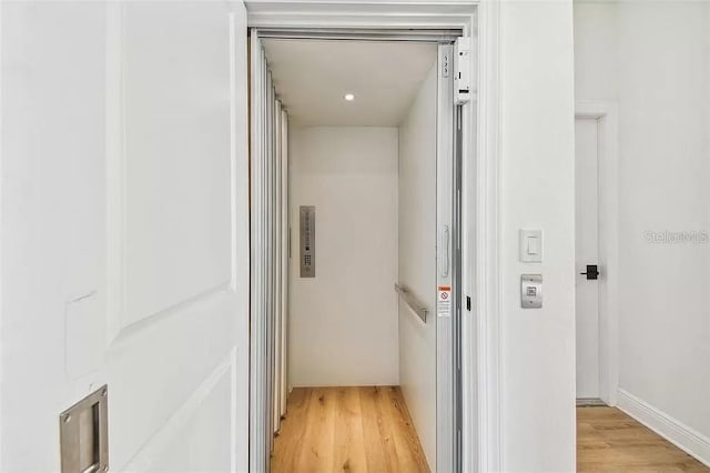 interior space with hardwood / wood-style flooring and elevator