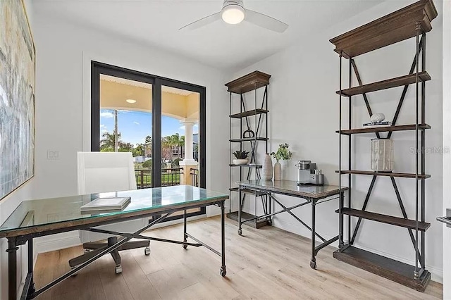 home office with ceiling fan and light hardwood / wood-style flooring