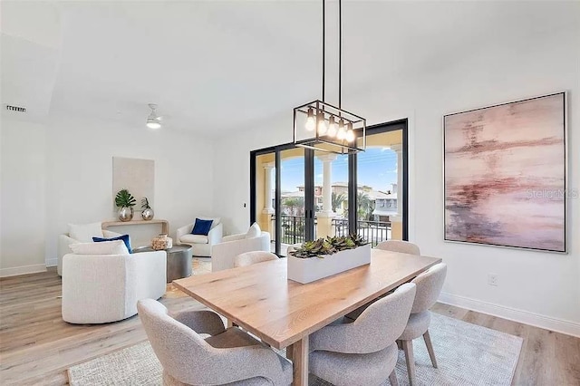 dining area featuring ceiling fan and light wood-type flooring