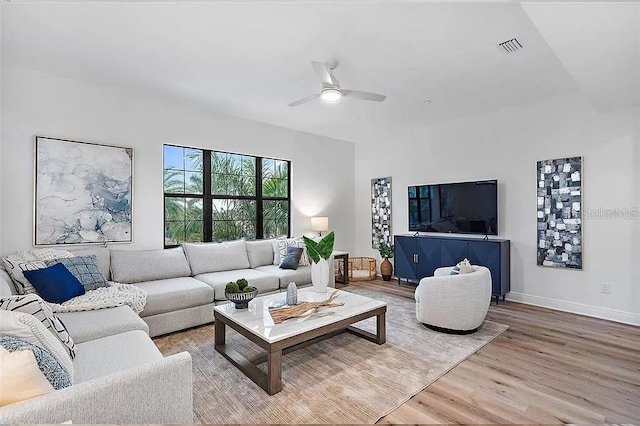 living room featuring ceiling fan and wood-type flooring