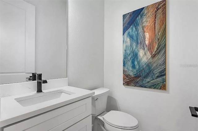 bathroom with vanity and toilet