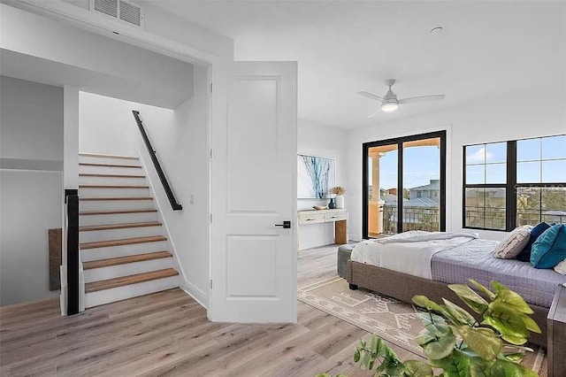 bedroom featuring access to outside, light hardwood / wood-style floors, and ceiling fan