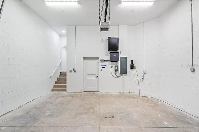 garage with electric panel and a garage door opener