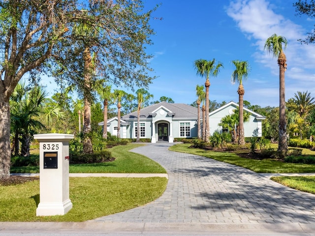 ranch-style house with french doors and a front yard