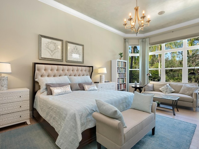 bedroom with hardwood / wood-style flooring, crown molding, and a notable chandelier