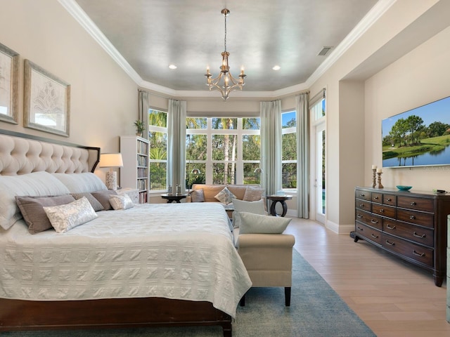 bedroom with a chandelier, crown molding, and light hardwood / wood-style floors