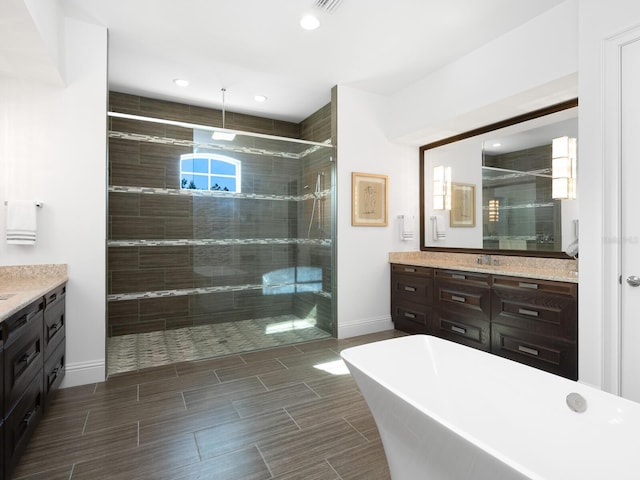 bathroom featuring vanity and separate shower and tub