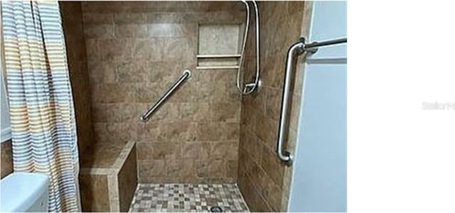 bathroom with a tile shower