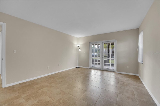 tiled spare room with french doors