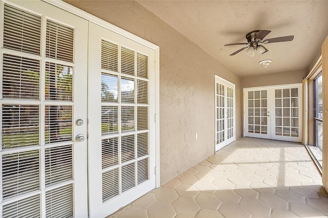 unfurnished sunroom featuring french doors and ceiling fan