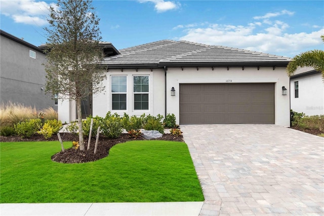 view of front facade with a garage and a front lawn