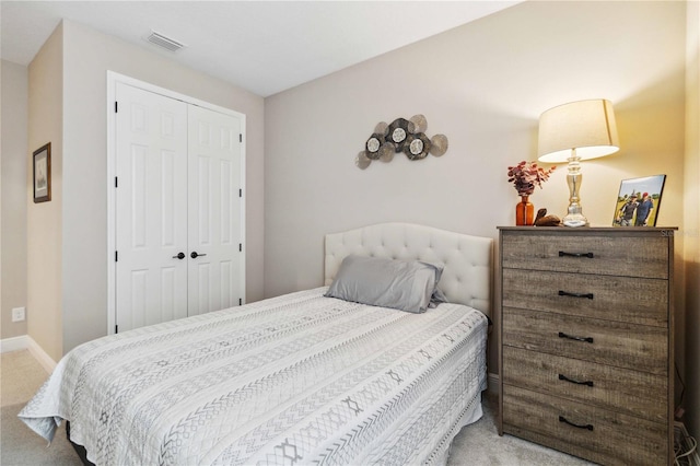 carpeted bedroom with a closet