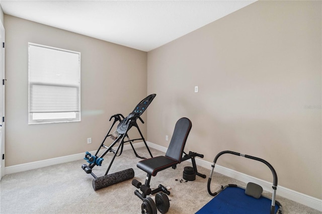 exercise area featuring light colored carpet