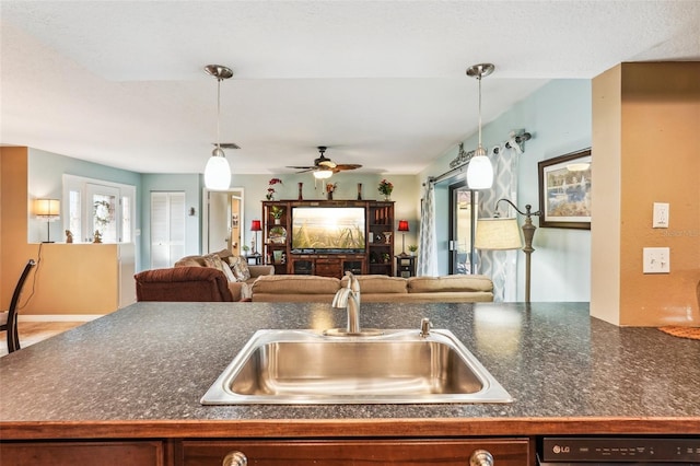 kitchen featuring ceiling fan, sink, dishwasher, and hanging light fixtures