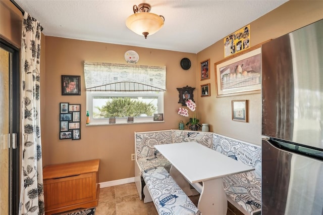 office space with a textured ceiling and breakfast area