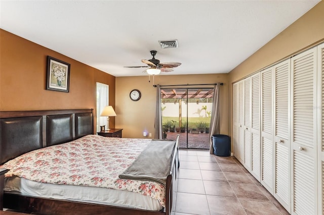 tiled bedroom with ceiling fan, access to outside, and a closet