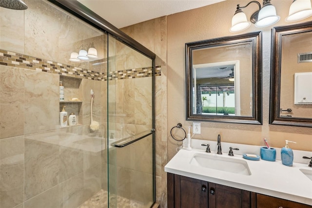 bathroom featuring vanity and an enclosed shower