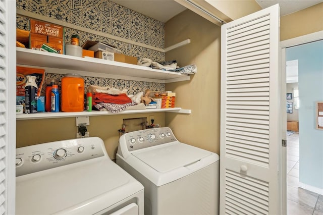 laundry room with tile patterned floors and washing machine and clothes dryer