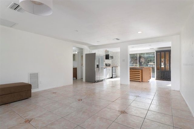 unfurnished living room with light tile patterned floors