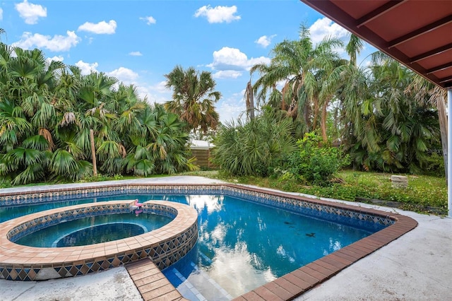 view of pool with an in ground hot tub