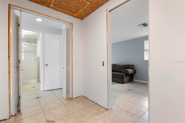 hallway featuring light tile patterned floors