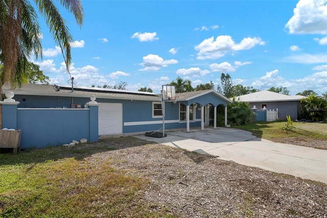 ranch-style home with a garage and a front lawn