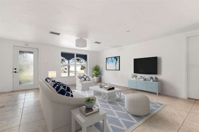 living area featuring visible vents and light tile patterned floors