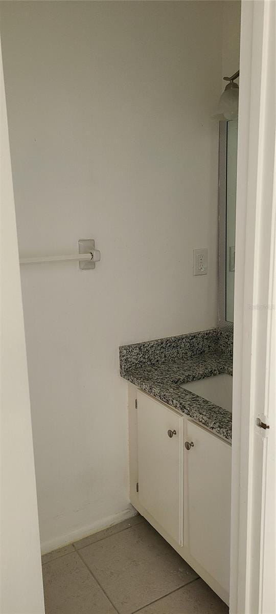 bathroom with tile patterned floors and vanity