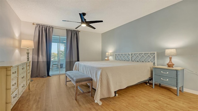 bedroom featuring a textured ceiling, light wood-type flooring, access to outside, and ceiling fan