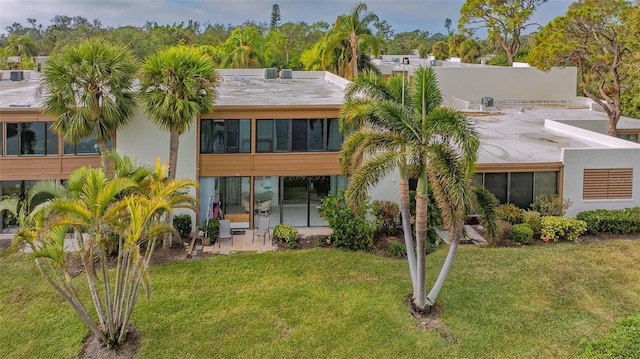 rear view of house with a yard and a patio