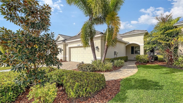 view of front of house with a garage and a front lawn