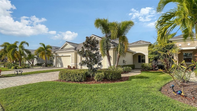 view of front of property with a garage and a front lawn