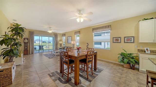 tiled dining space with ceiling fan