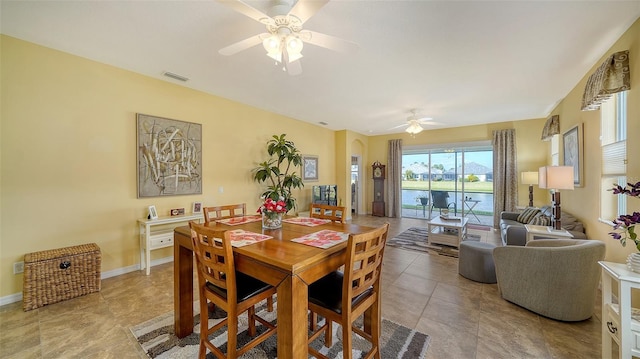 tiled dining area featuring ceiling fan