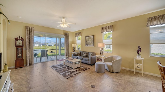 living room featuring ceiling fan, a healthy amount of sunlight, and light tile patterned flooring