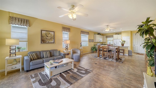 living room with ceiling fan and light tile patterned flooring