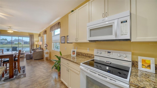 kitchen with stone countertops, ceiling fan, white appliances, and light tile patterned floors