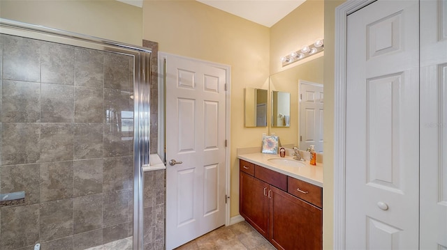 bathroom featuring tile patterned flooring, vanity, and a shower with door