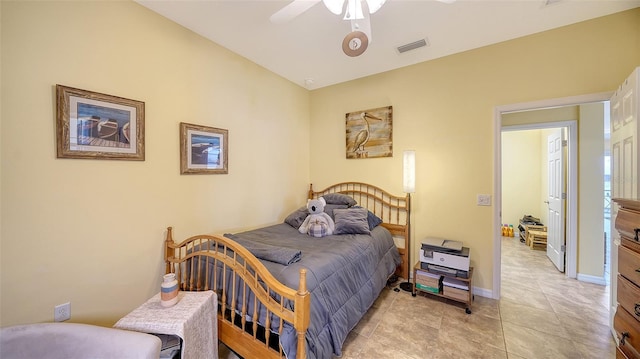 bedroom with ceiling fan and light tile patterned floors